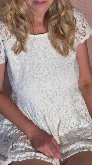 Lifting the white dress so you can see the rest